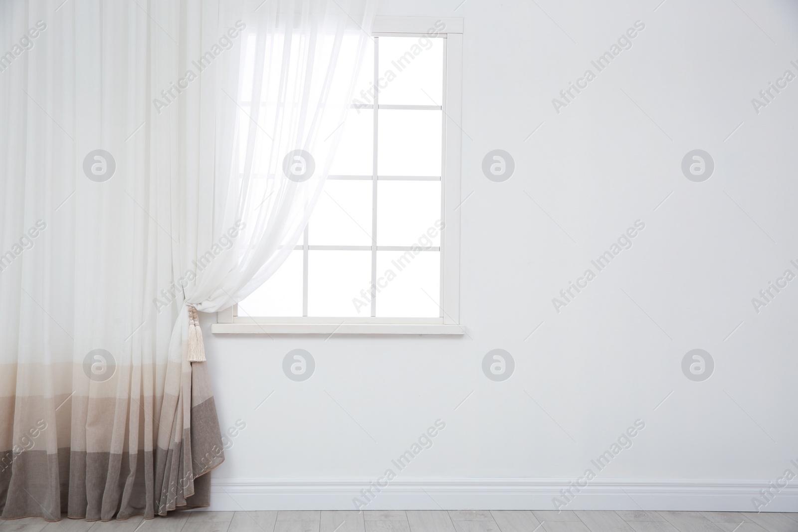 Photo of Modern window with curtain in room, space for text. Home interior