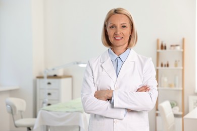 Portrait of happy dermatologist in modern clinic