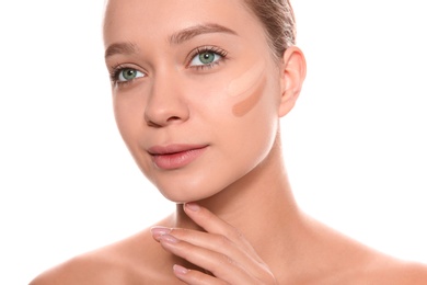 Photo of Young woman with different shades of skin foundation on her face against white background