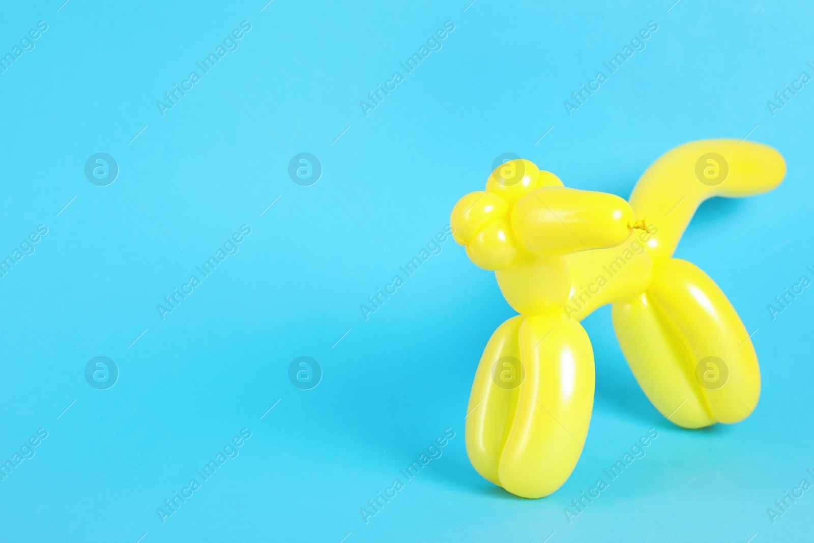 Photo of Animal figure made of modelling balloon on color background. Space for text