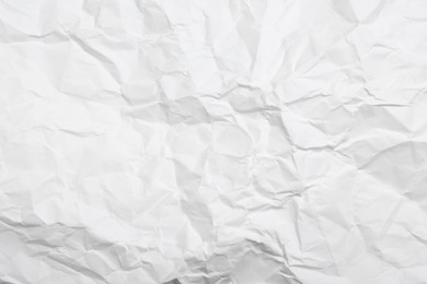 Photo of Sheet of white crumpled paper as background, closeup