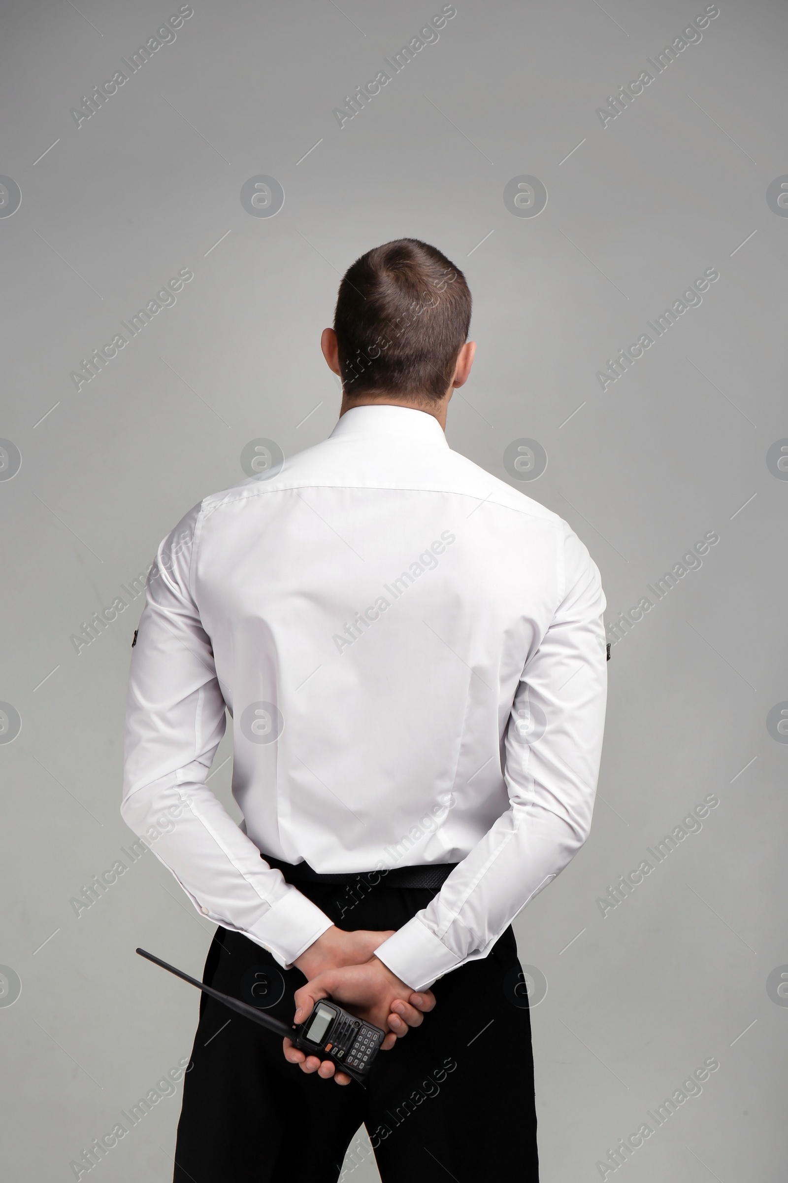 Photo of Male security guard in uniform on color background