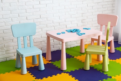 Stylish playroom interior with toys and modern furniture