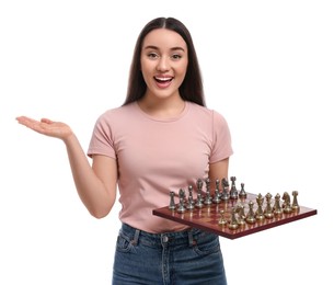 Photo of Happy woman holding chessboard with game pieces white background