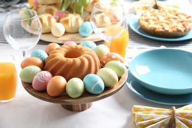 Festive Easter table setting with traditional meal, space for text