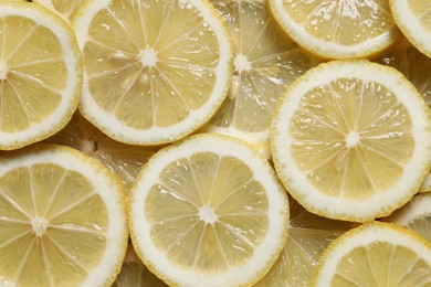 Photo of Slices of fresh lemons as background, top view
