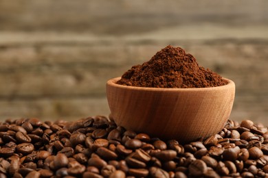 Photo of Bowl of ground coffee on roasted beans, closeup