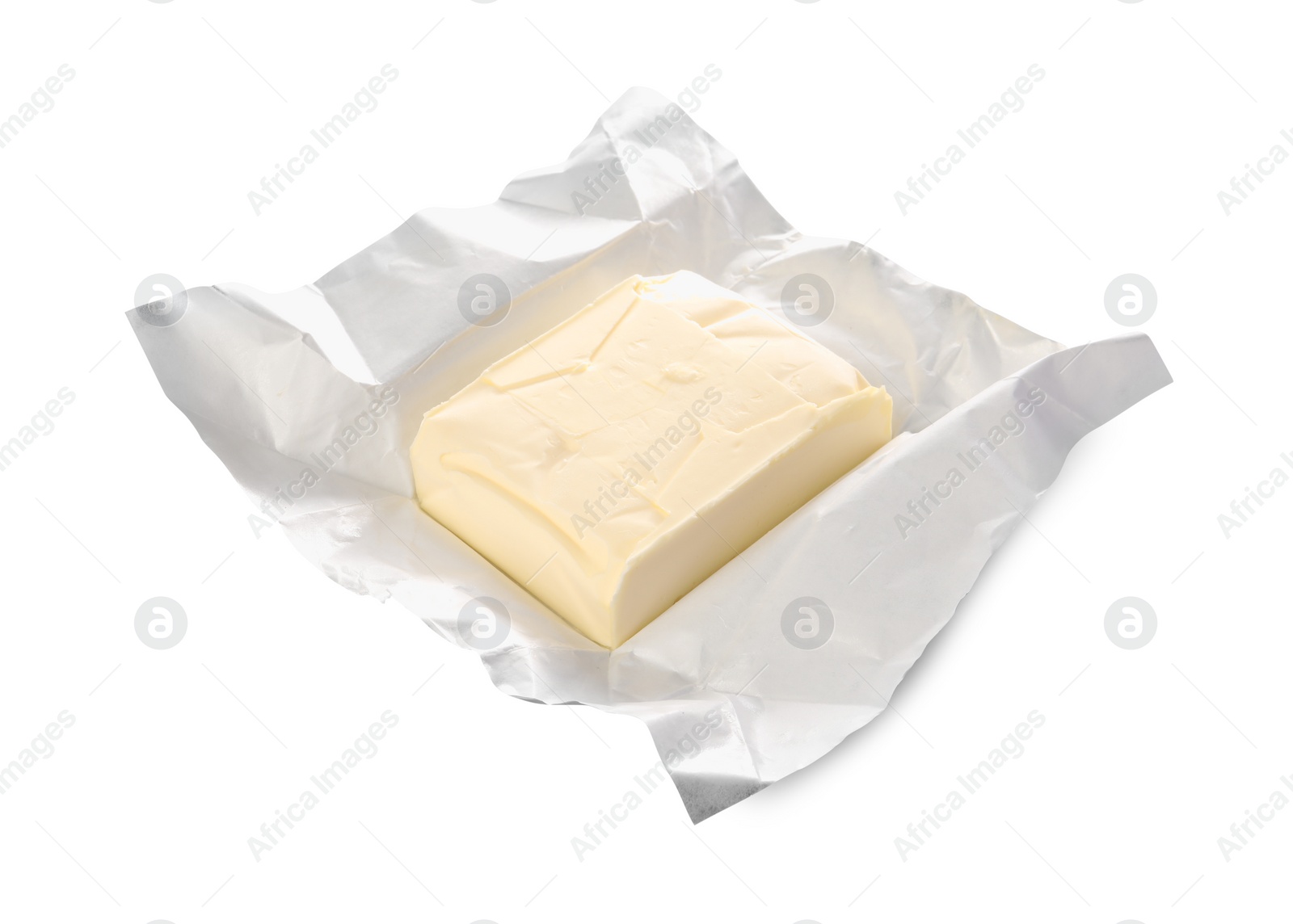 Photo of Block of tasty butter in open foil packaging isolated on white