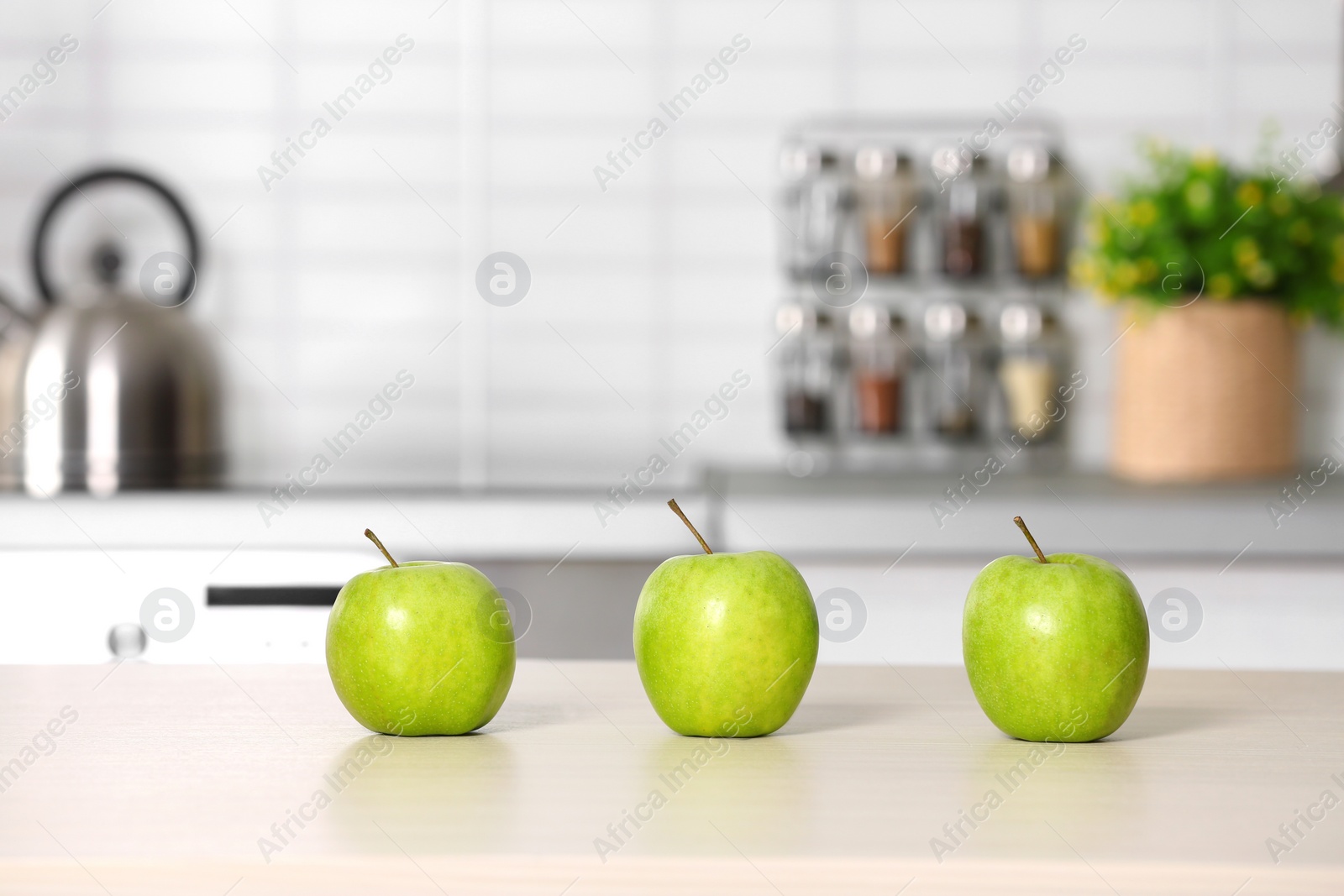 Photo of Fresh green apples on kitchen counter. Space for text