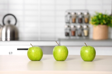 Photo of Fresh green apples on kitchen counter. Space for text