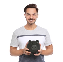 Portrait of young man with piggy bank on white background