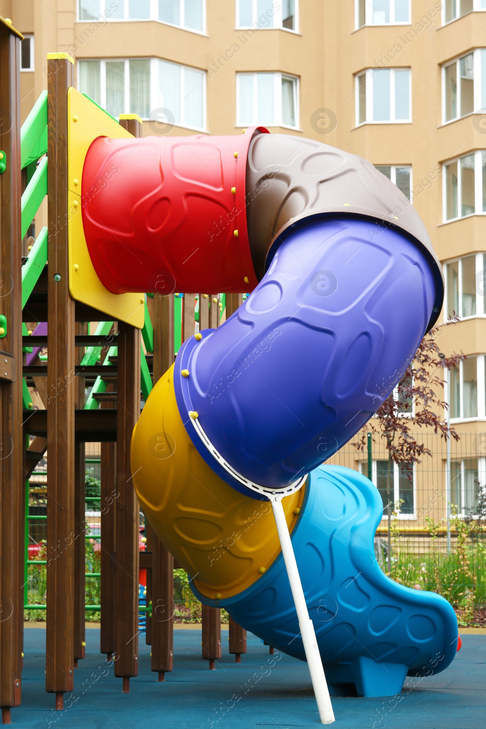 Photo of Colourful slide on outdoor playground for children in residential area