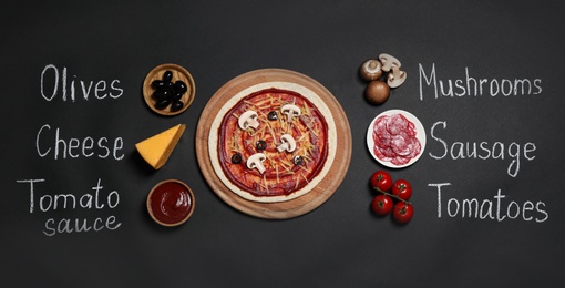 Pizza crust, ingredients and chalk written product's names on black background, flat lay