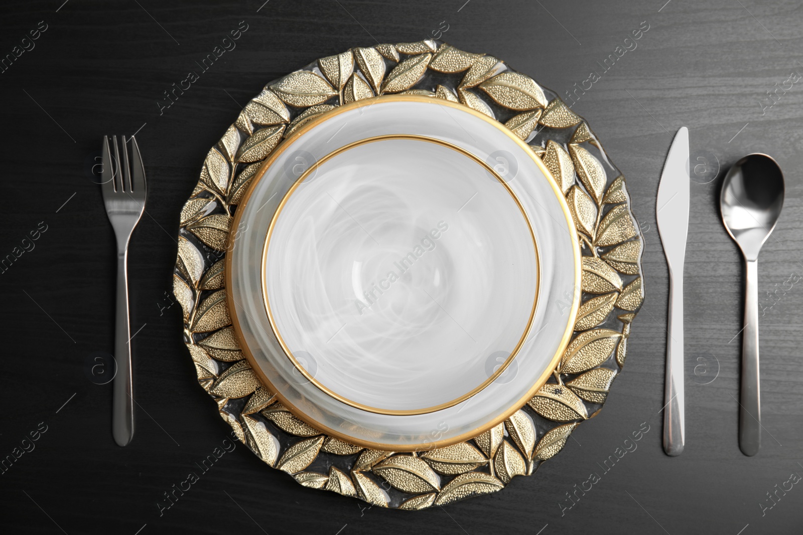 Photo of Elegant table setting on dark background, top view