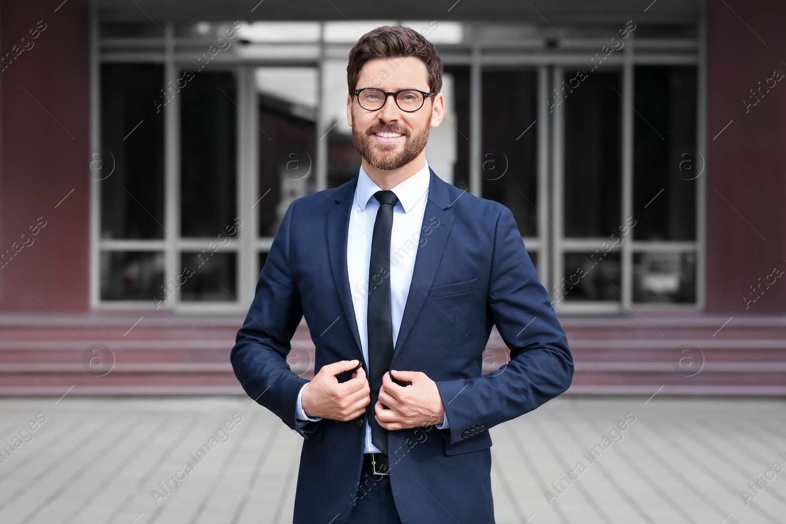 Photo of Handsome real estate agent in nice suit outdoors