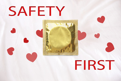 Image of Safety first. Golden condom package on color background, top view 