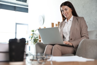 Photo of Female business trainer working with laptop in office