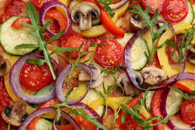 Delicious hot vegetable pizza with mushrooms as background, closeup