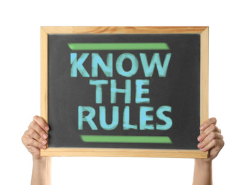 Image of Woman holding chalkboard with phrase Know the rules on white background, closeup