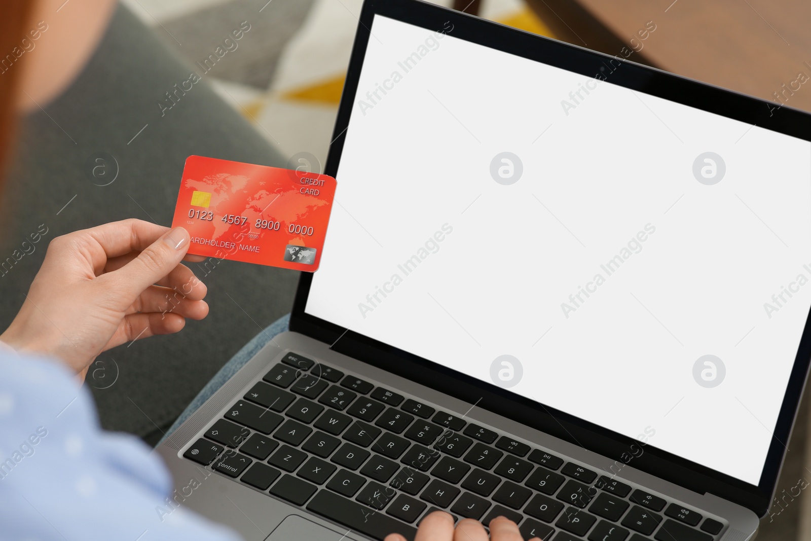 Photo of Woman with credit card using laptop for online shopping, closeup