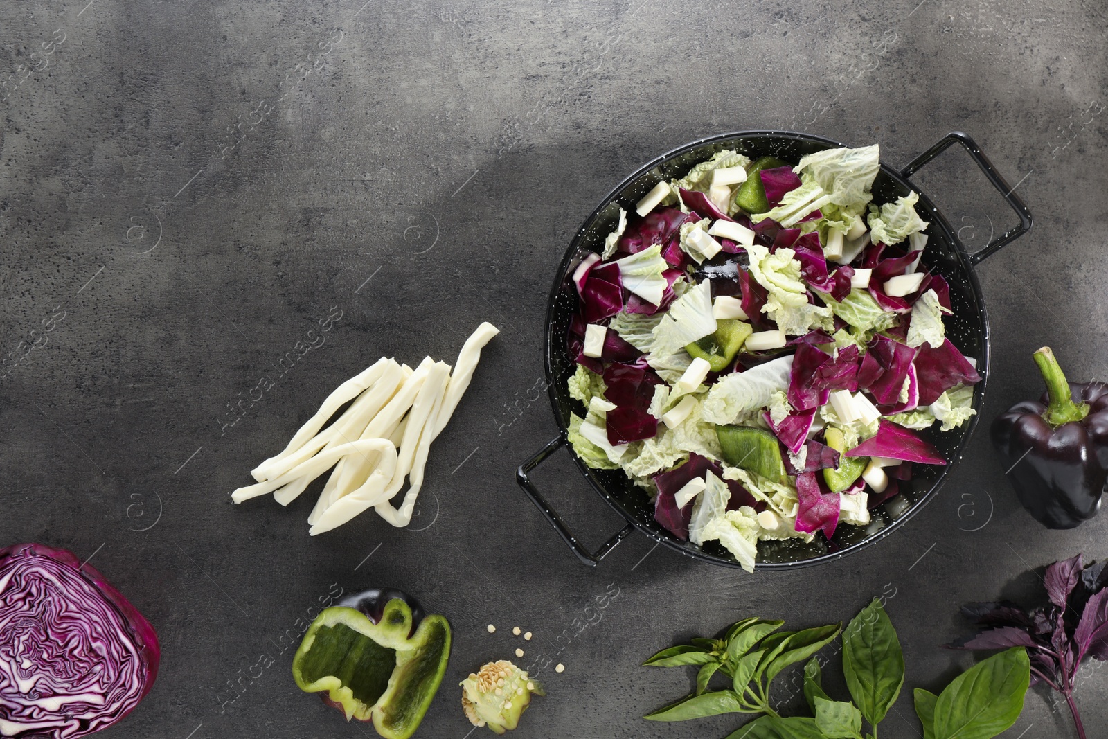 Photo of Delicious salad with Chinese cabbage, suluguni cheese and bell pepper on grey table, flat lay. Space for text