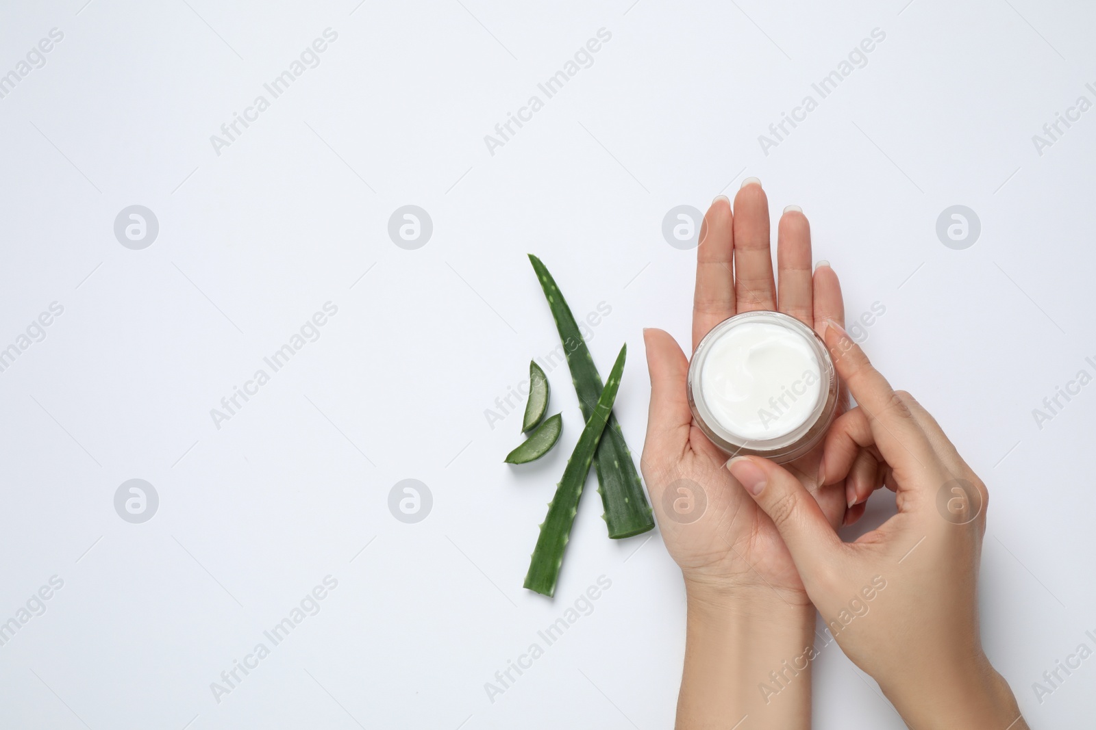 Photo of Woman with cosmetic product and aloe on white background, top view