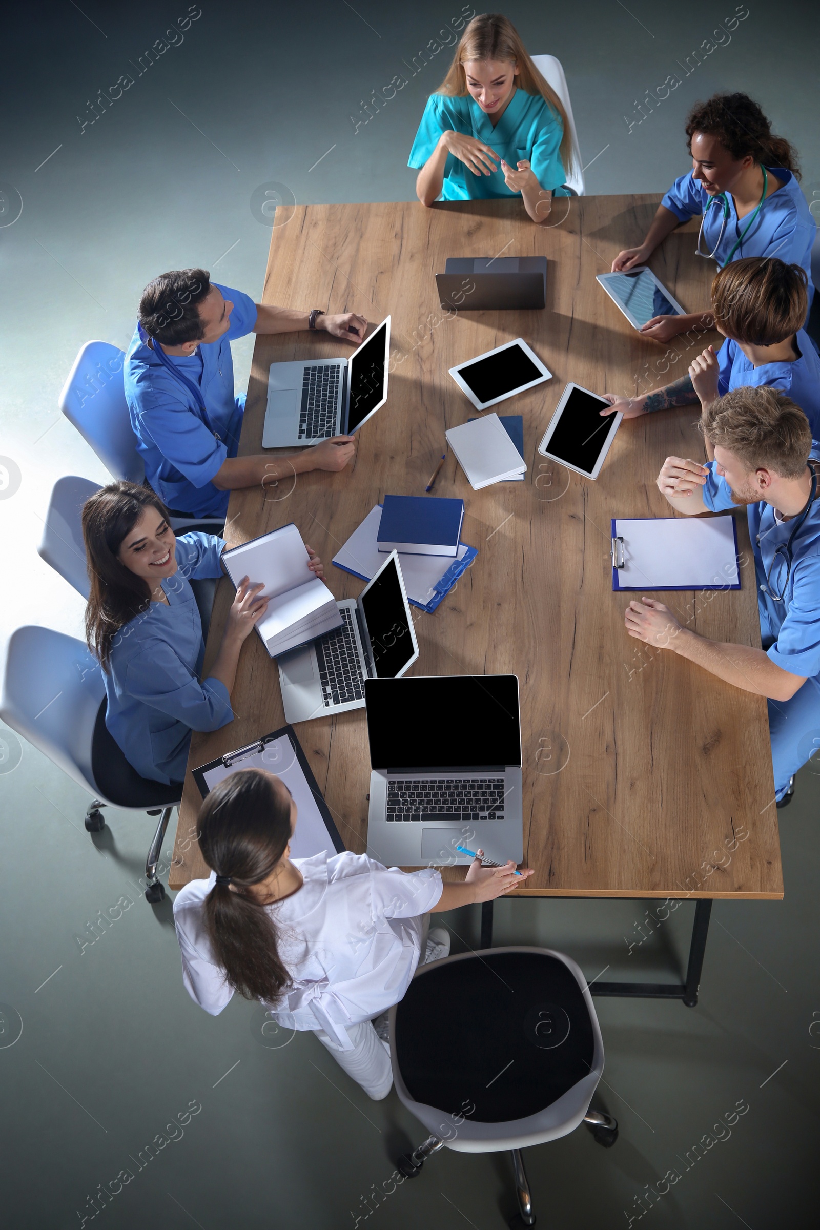 Photo of Group of medical students with gadgets in college, top view