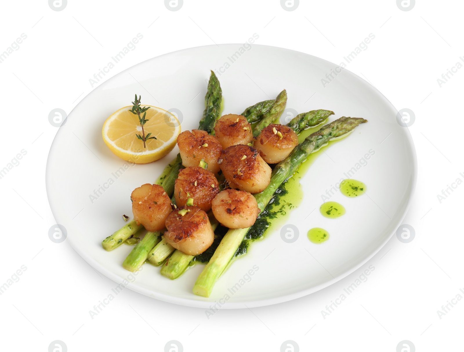 Photo of Delicious fried scallops with asparagus, lemon and thyme isolated on white