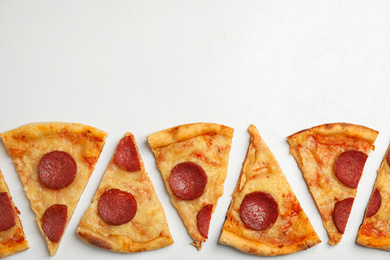 Photo of Tasty pepperoni pizza on white table, flat lay. Space for text