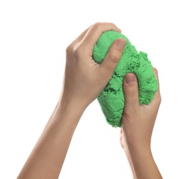 Photo of Woman playing with green kinetic sand on white background, closeup