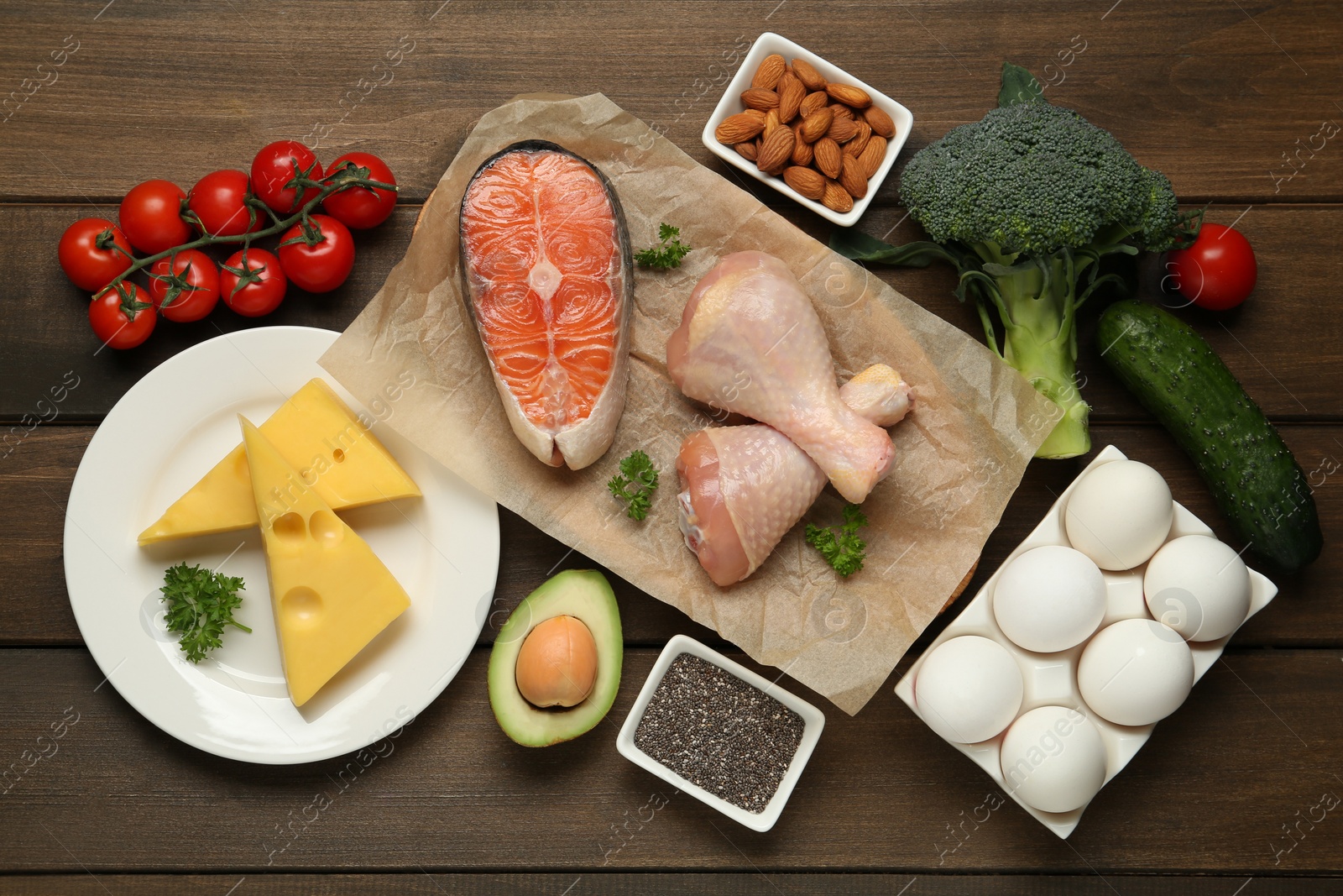 Photo of Flat lay composition with keto diet products on wooden table