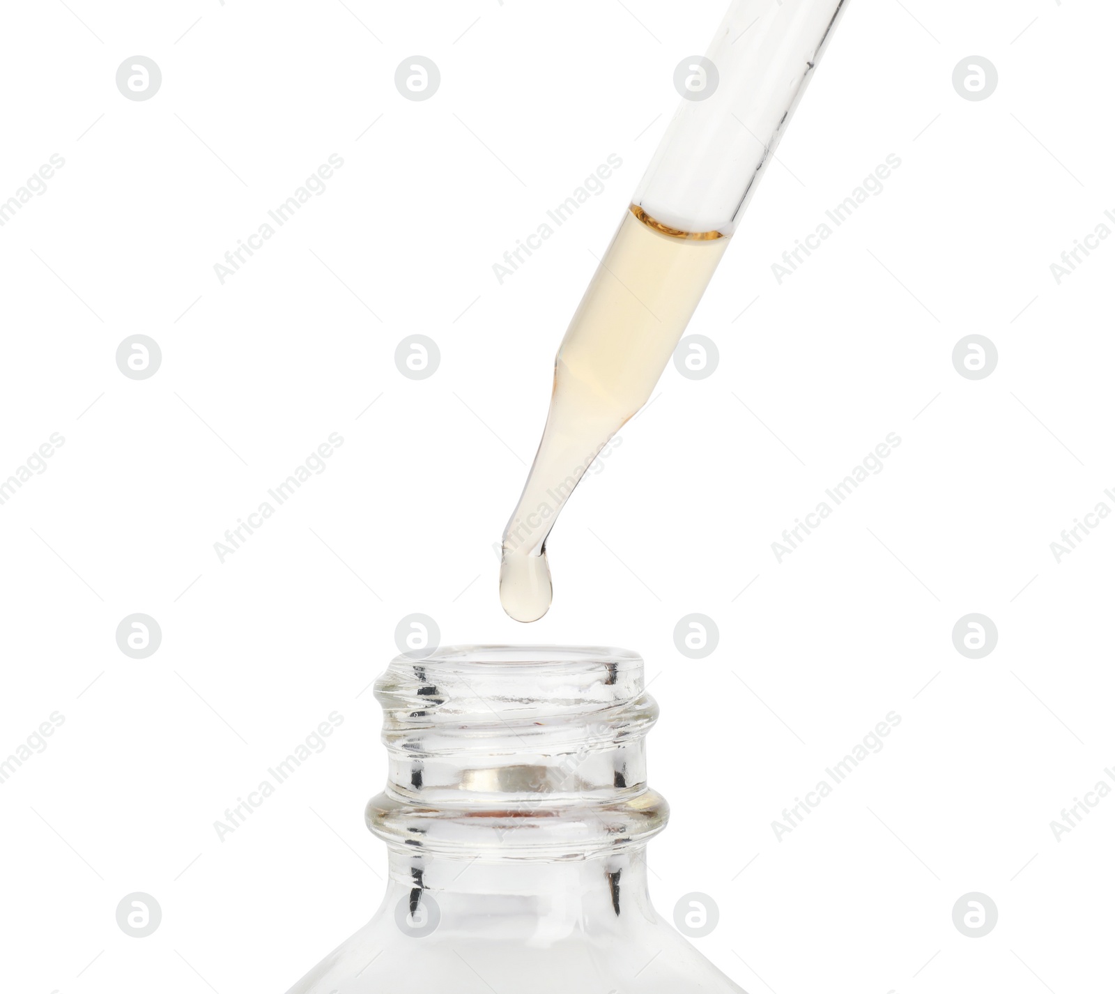 Photo of Essential oil dripping from pipette into glass bottle on white background