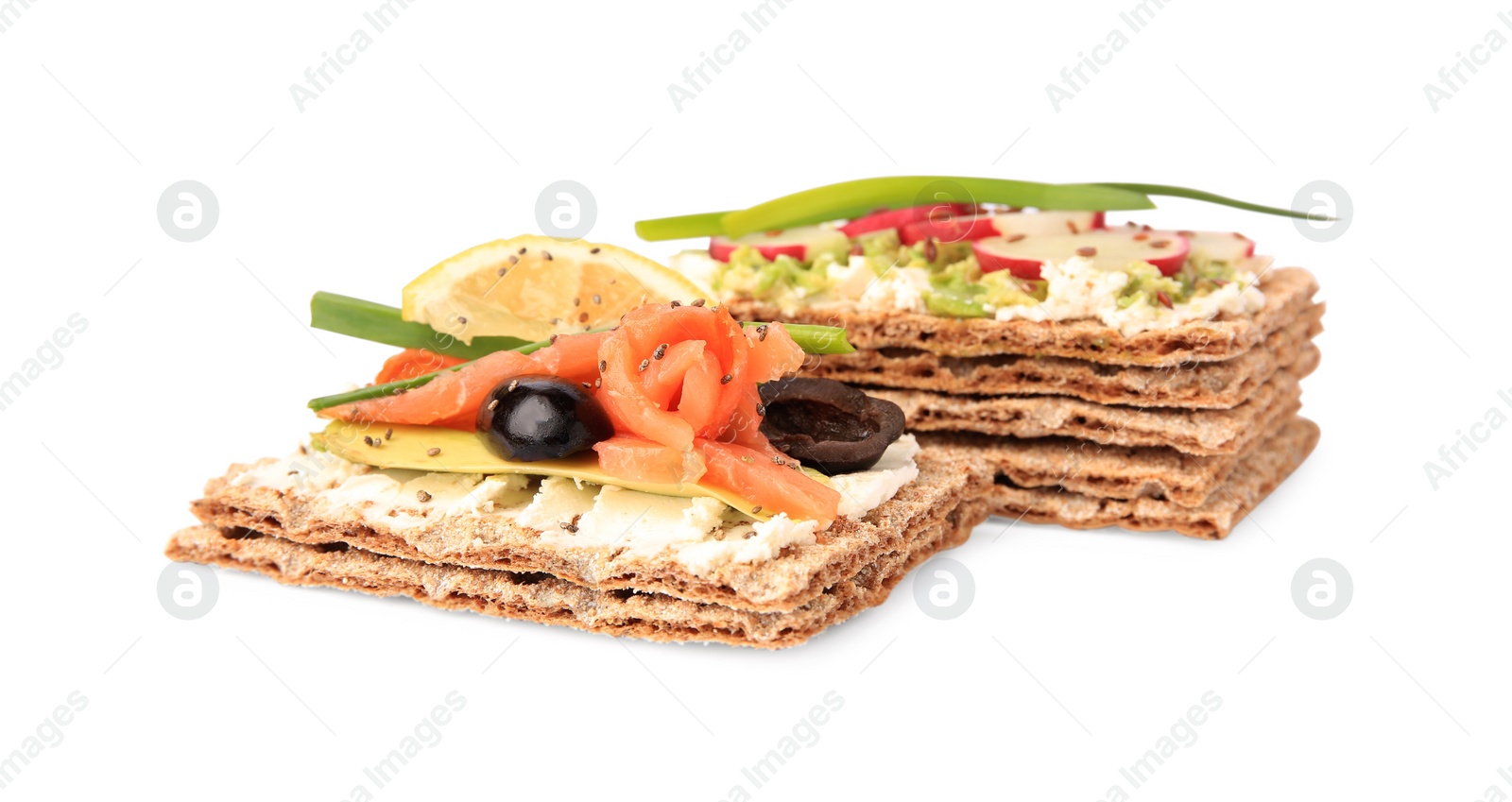 Photo of Fresh crunchy crispbreads with cream cheese, salmon, olives, lemon, radish green onion on white background