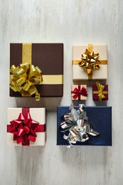 Photo of Flat lay composition with beautiful gift boxes on white wooden table