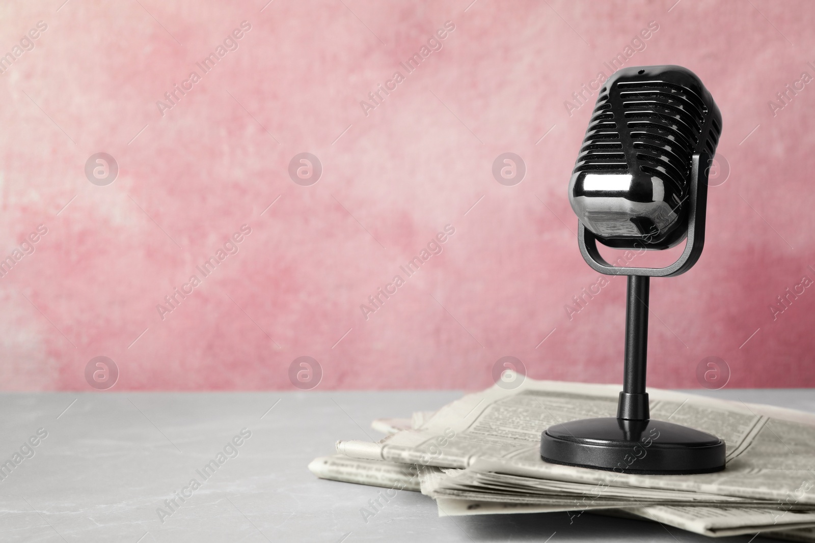 Photo of Newspapers and vintage microphone on table, space for text. Journalist's work