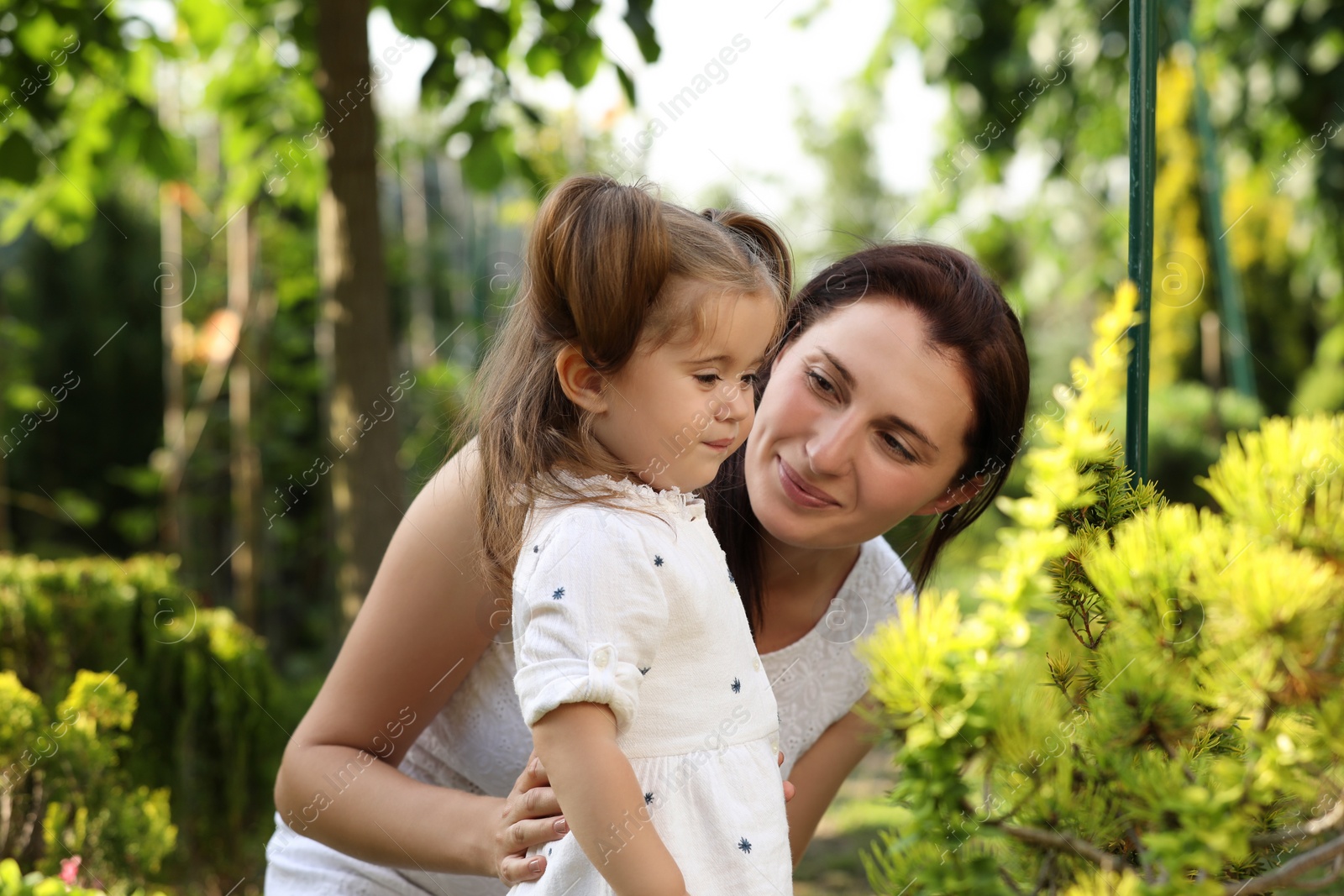 Photo of Mother with her cute daughter spending time together in park