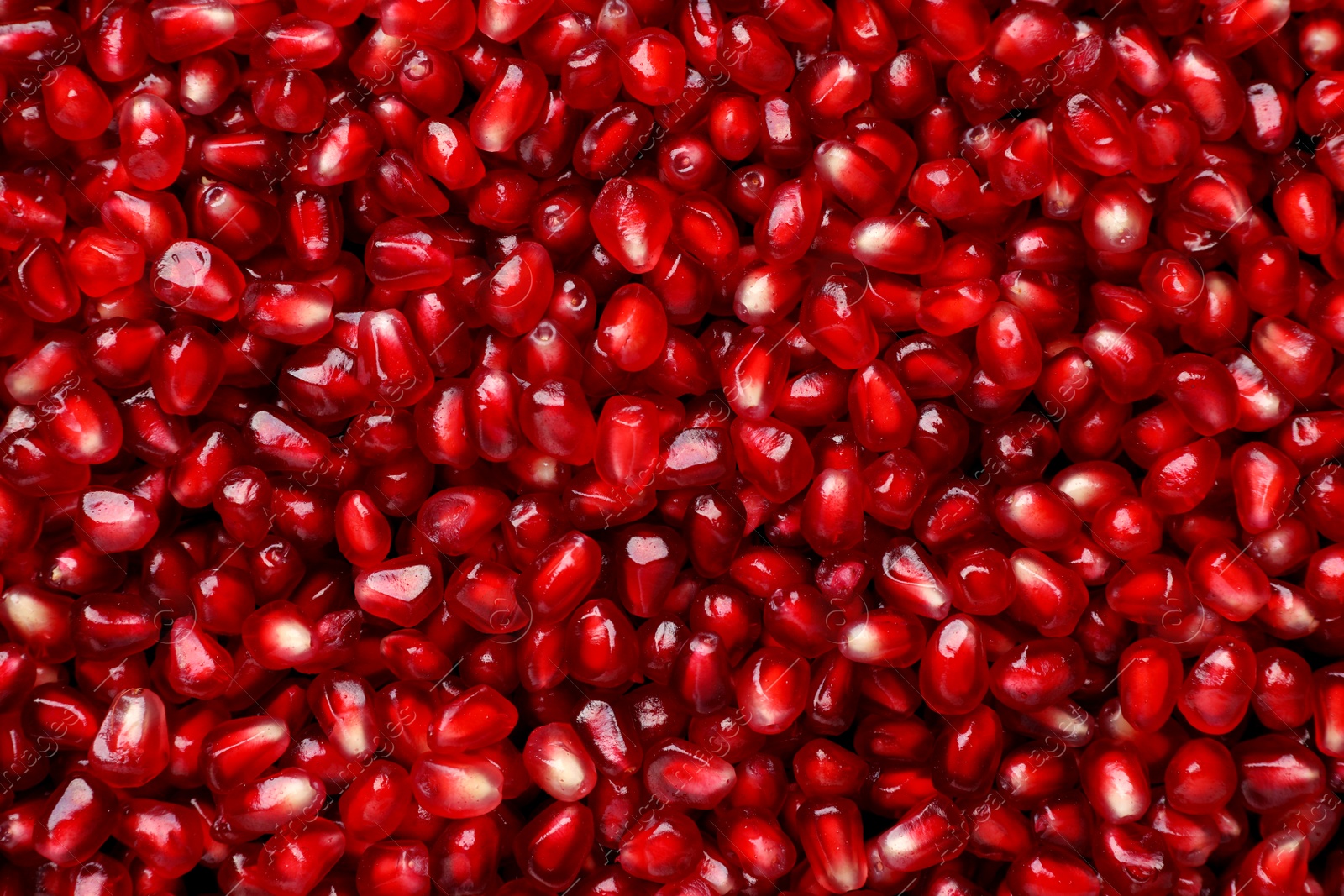 Photo of Tasty pomegranate seeds as background, top view