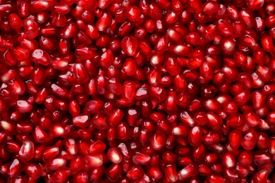 Tasty pomegranate seeds as background, top view