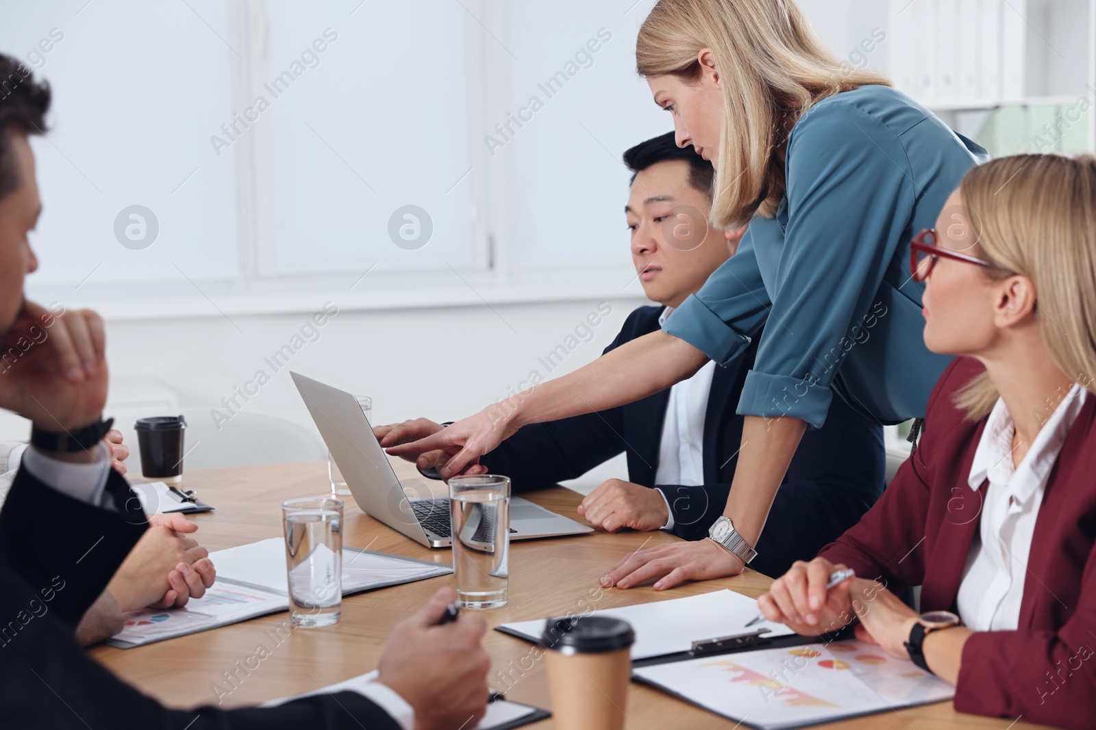 Photo of Businesswoman having meeting with her employees in office