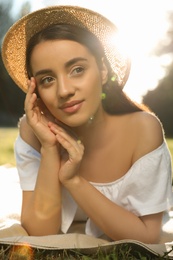 Beautiful young woman in park on sunny day