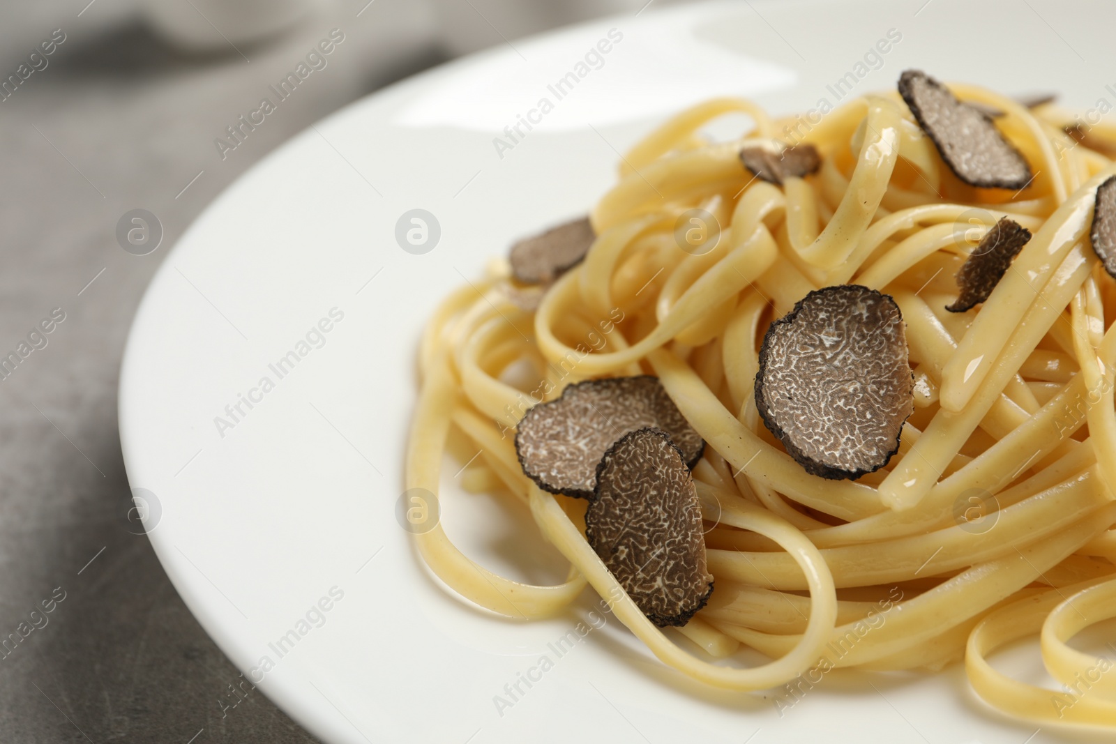 Photo of Tasty fettuccine with truffle on plate, closeup