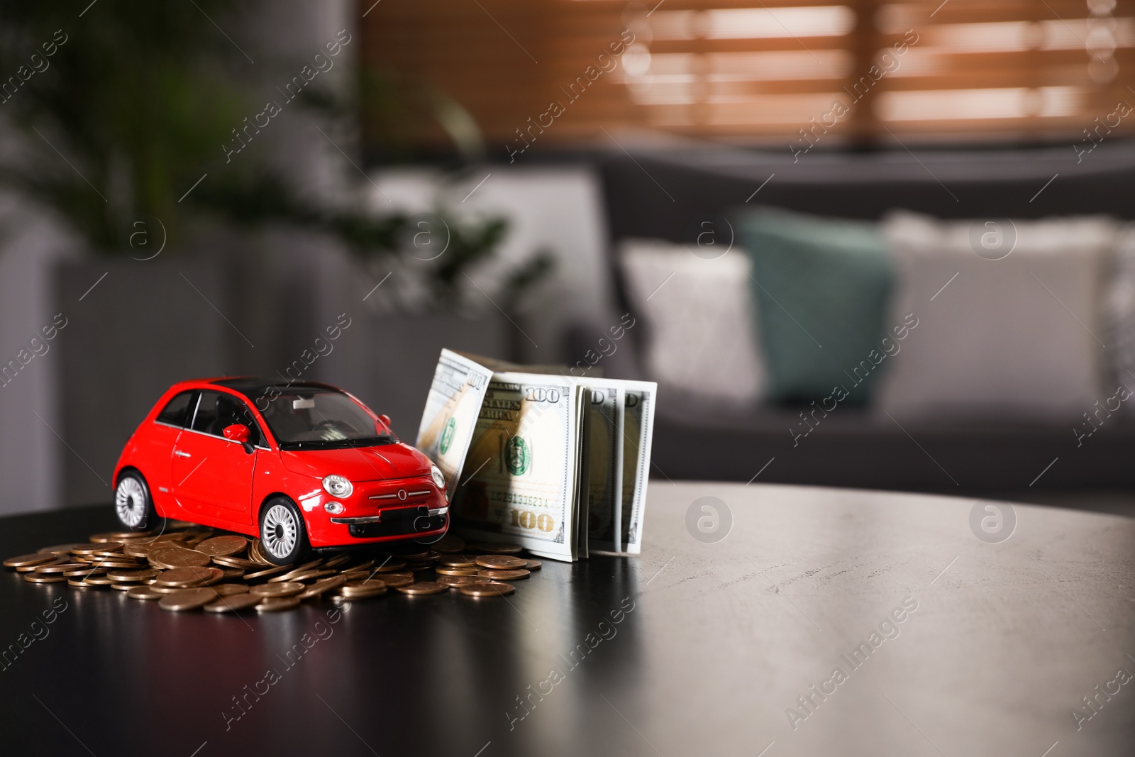 Photo of Miniature automobile model and money on table indoors, space for text. Car buying