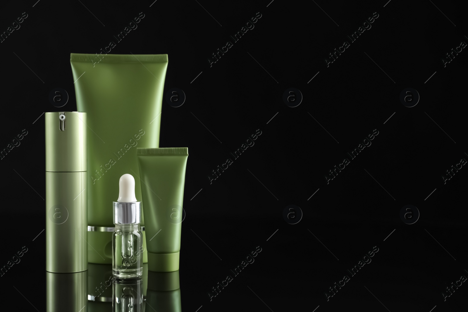 Photo of Set of cosmetic products on black background, space for text