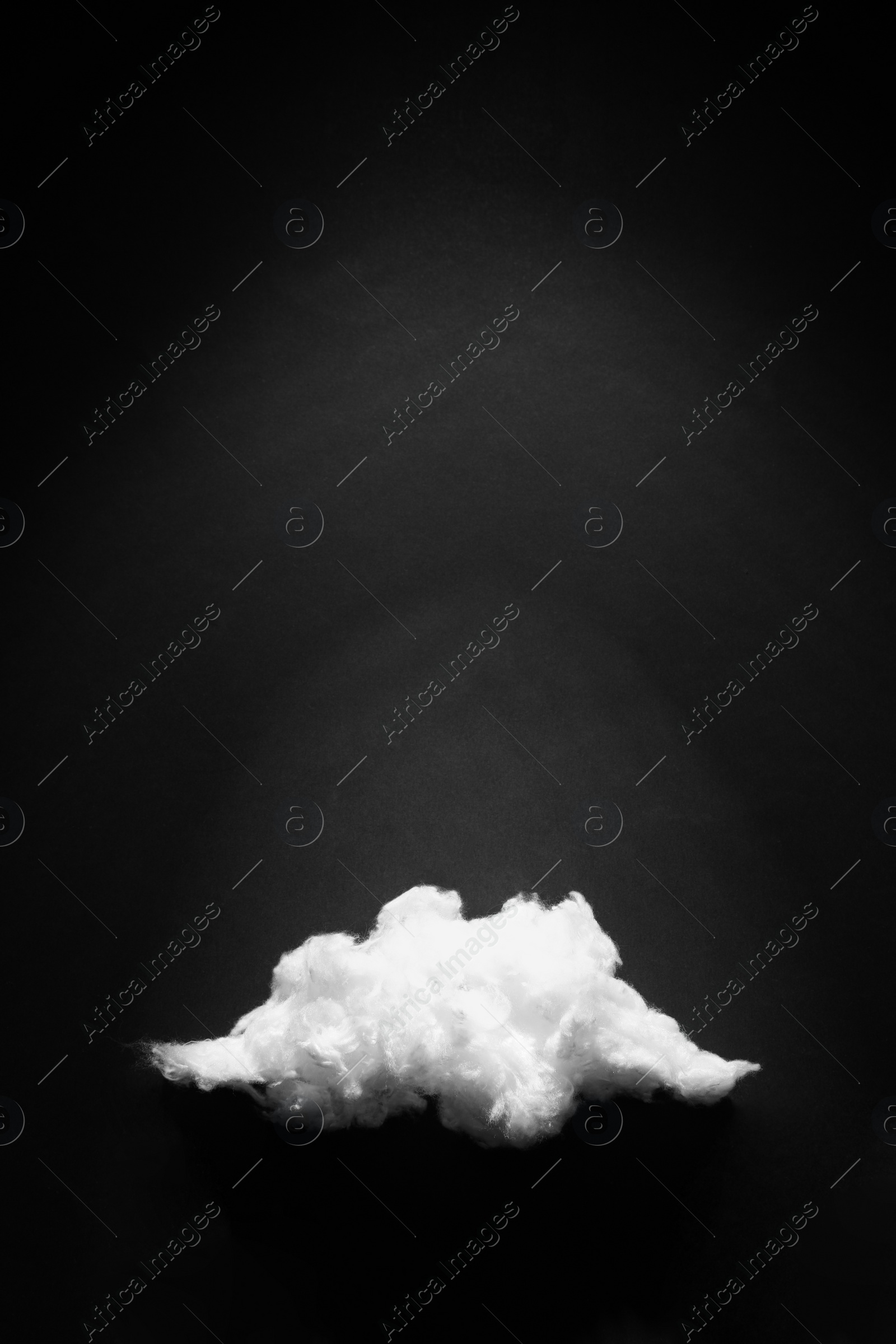 Photo of Cloud made of cotton on black background. Space for text
