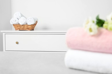 Photo of Different folded soft terry towels in room