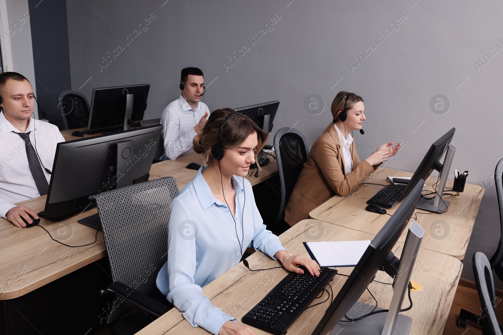 Photo of Call center operators working in modern office