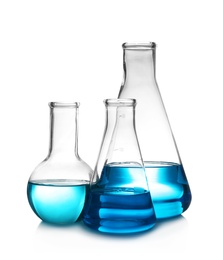 Laboratory glassware with liquid on table against white background. Chemical analysis