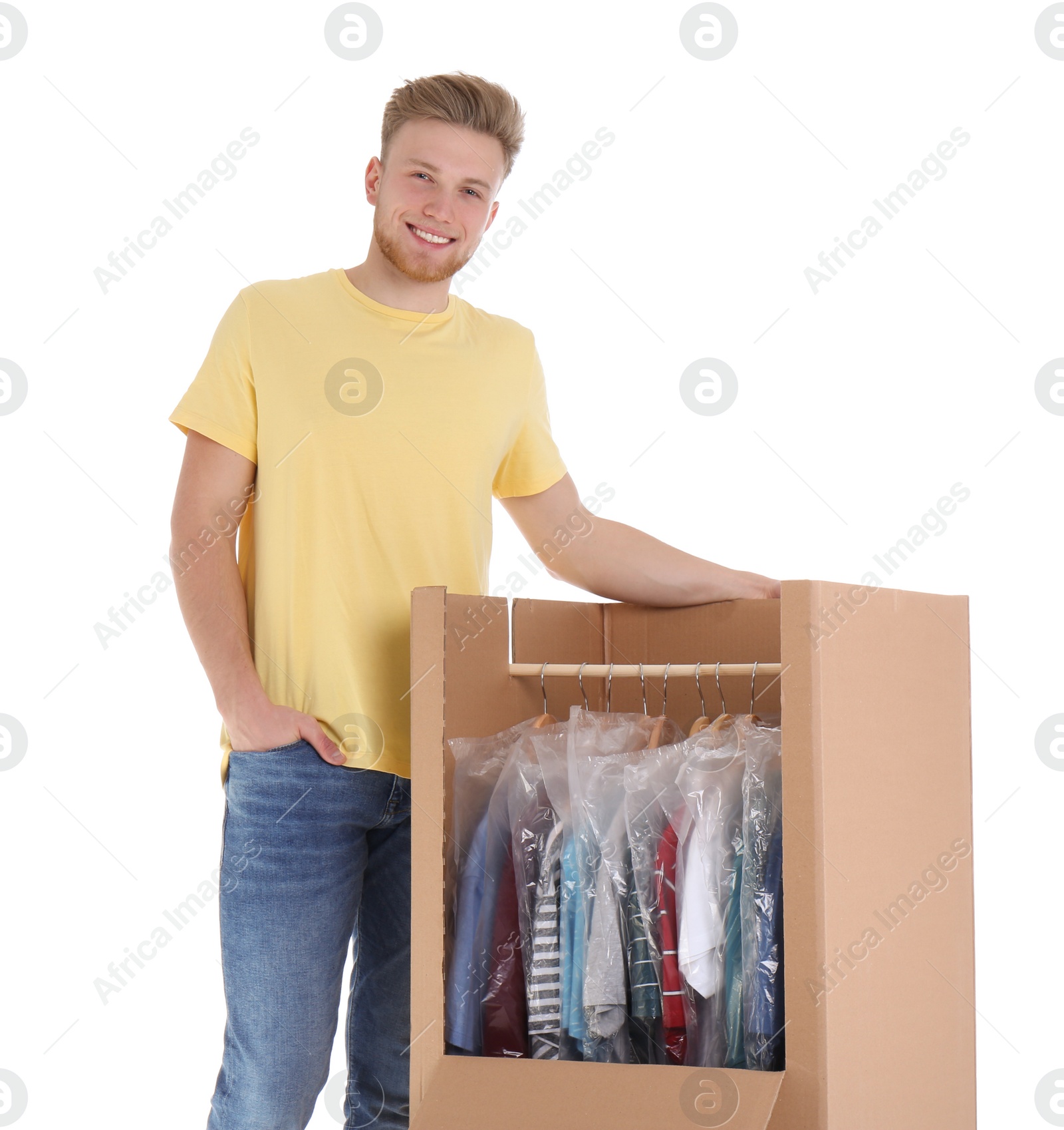 Photo of Young man near wardrobe box on white background