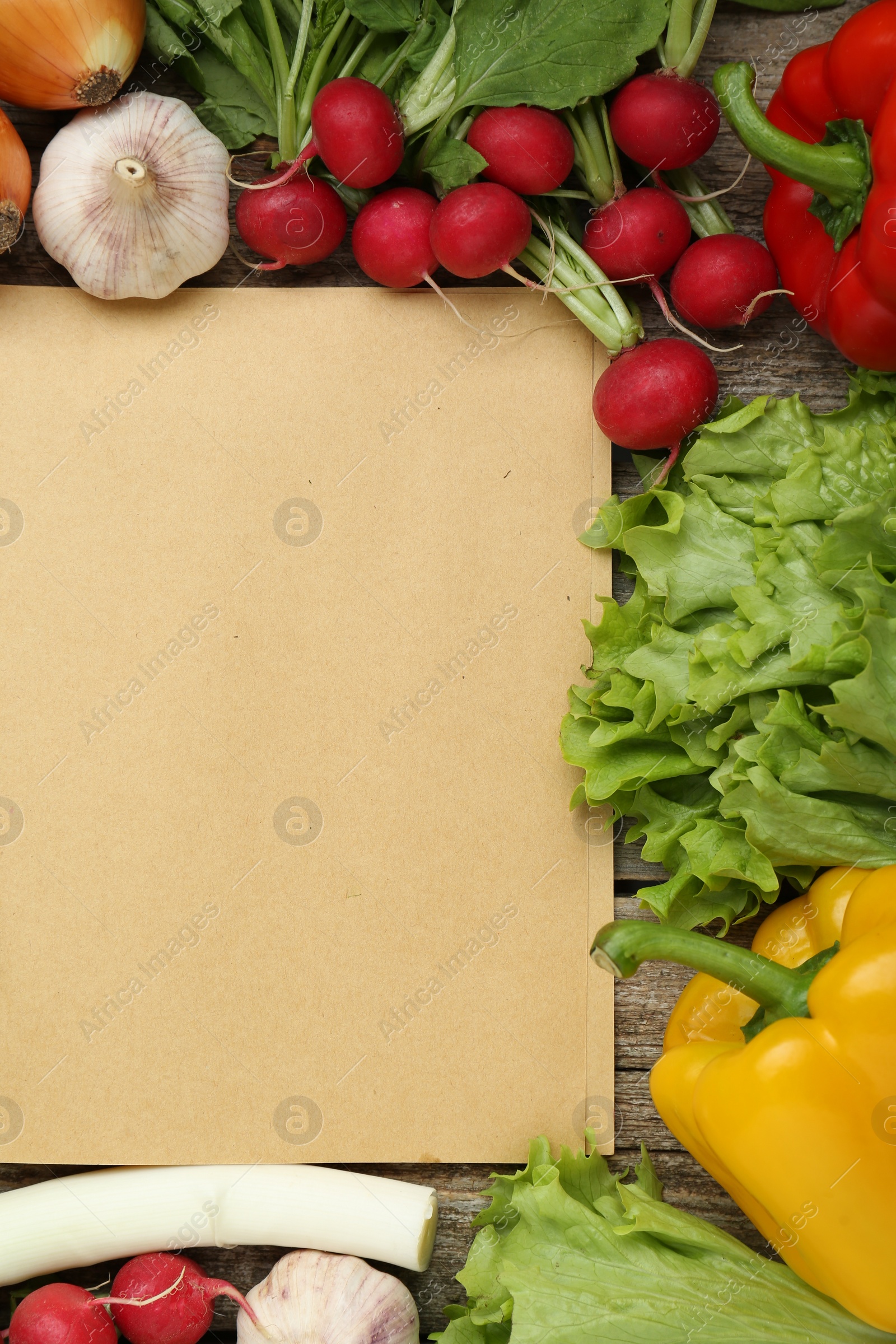 Photo of Blank recipe book and different ingredients on wooden table, flat lay. Space for text