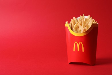 Photo of MYKOLAIV, UKRAINE - AUGUST 12, 2021: Big portion of McDonald's French fries on red background. Space for text